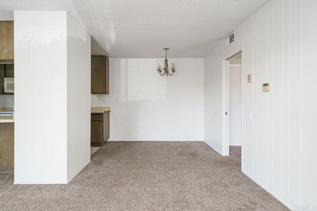 5700 Baltimore Dr Unit 134, La Mesa, CA 91942 - unfurnished living room with carpet floors, a chandelier, and a textured ceiling
