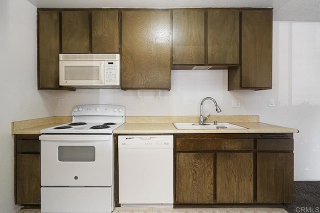 5700 Baltimore Dr Unit 134, La Mesa, CA 91942 - kitchen with white appliances, a sink, dark brown cabinets, and light countertops