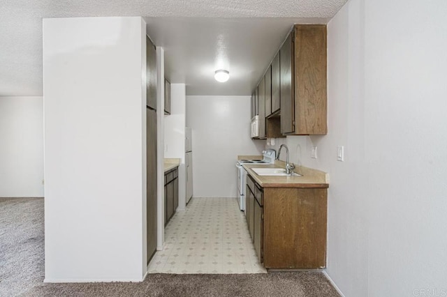 5700 Baltimore Dr Unit 134, La Mesa, CA 91942 - kitchen with white appliances, a sink, light countertops, light floors, and a textured ceiling