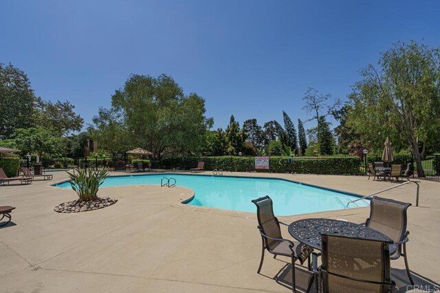 5700 Baltimore Dr Unit 134, La Mesa, CA 91942 - community pool with a patio area and view of scattered trees