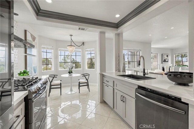 21011 Marin Unit 103, Lake Forest, CA 92630 - kitchen featuring stainless steel appliances, light countertops, ornamental molding, recessed lighting, and a chandelier