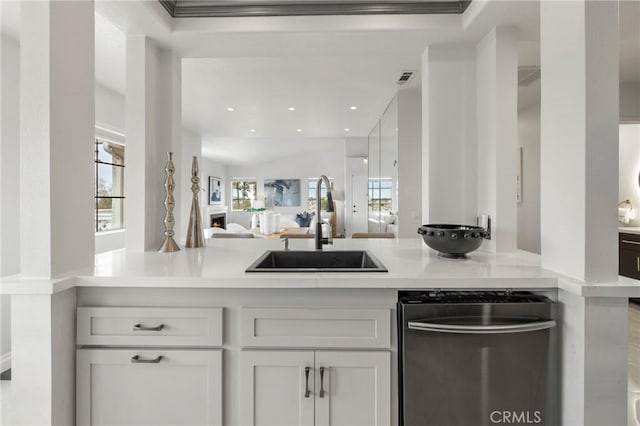 21011 Marin Unit 103, Lake Forest, CA 92630 - kitchen featuring light countertops, stainless steel dishwasher, open floor plan, white cabinetry, and recessed lighting