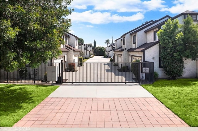 11636 Lambert Ave Unit 12, El Monte, CA 91732 - view of concrete driveway featuring a residential view, a gated entry, and a gate