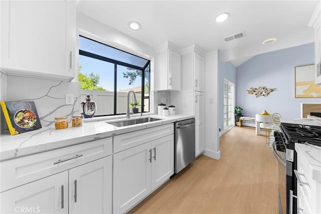 11636 Lambert Ave Unit 12, El Monte, CA 91732 - kitchen featuring stainless steel appliances, white cabinetry, light wood-style floors, recessed lighting, and light stone countertops