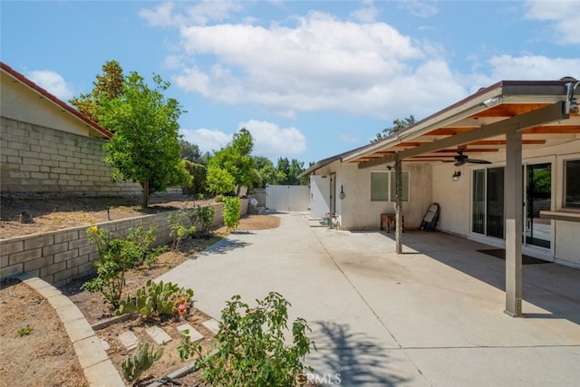 19941 Hiawatha St, Chatsworth, CA 91311 - fenced backyard with a ceiling fan, a patio area, and a gate