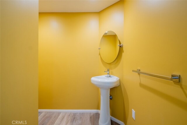 19941 Hiawatha St, Chatsworth, CA 91311 - bathroom featuring wood finished floors, baseboards, and a sink
