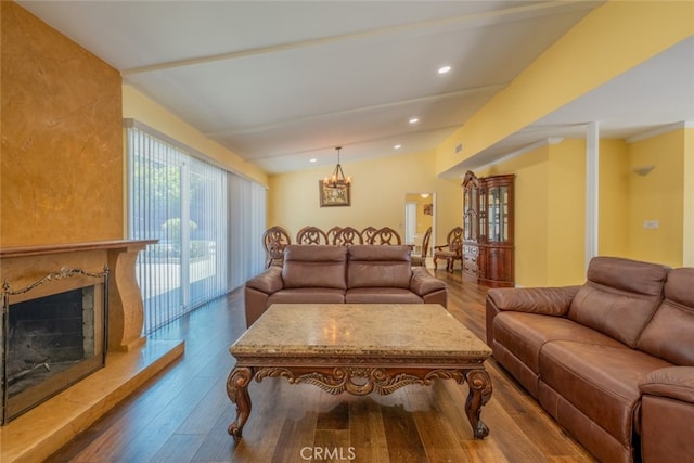19941 Hiawatha St, Chatsworth, CA 91311 - living area featuring dark wood finished floors, a chandelier, a high end fireplace, lofted ceiling, and recessed lighting