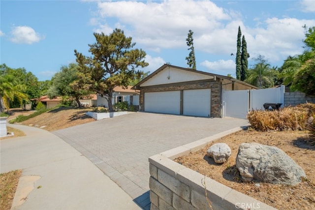19941 Hiawatha St, Chatsworth, CA 91311 - single story home featuring decorative driveway, stone siding, a garage, and stucco siding