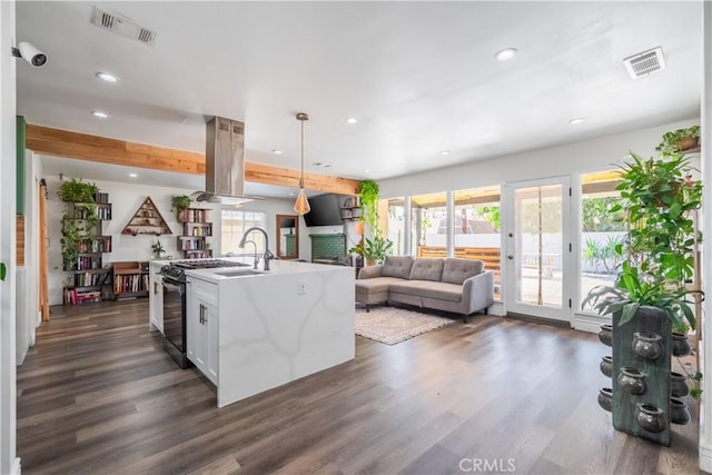 9551 Barkerville Ave, Whittier, CA 90605 - kitchen with recessed lighting, dark wood-style floors, island range hood, light countertops, and open floor plan