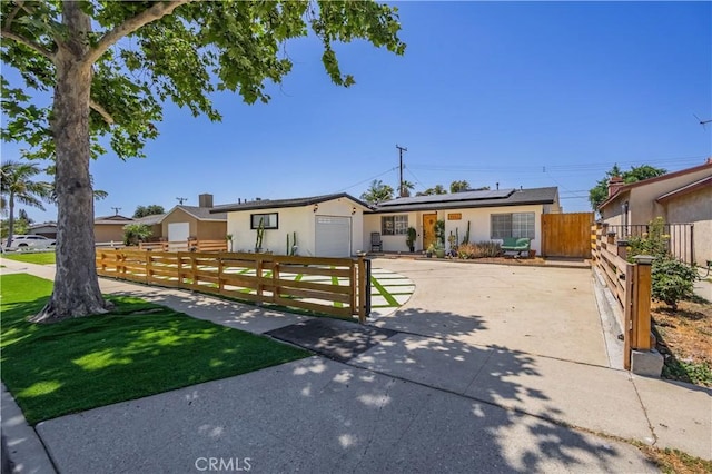 9551 Barkerville Ave, Whittier, CA 90605 - ranch-style home with a garage, solar panels, driveway, and stucco siding