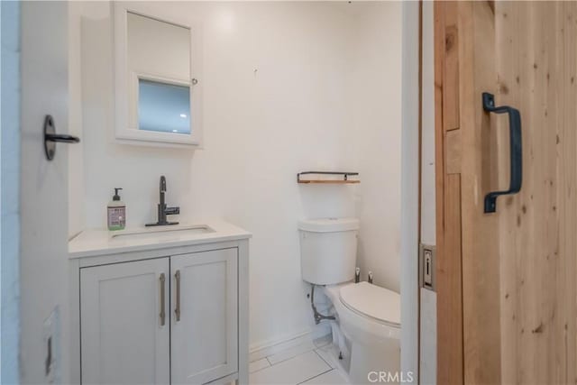 9551 Barkerville Ave, Whittier, CA 90605 - half bath featuring vanity, toilet, tile patterned flooring, and baseboards