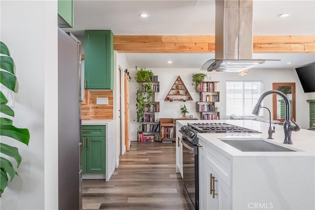 9551 Barkerville Ave, Whittier, CA 90605 - kitchen featuring green cabinets, island exhaust hood, stainless steel fridge, light countertops, and wood finished floors