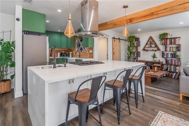 9551 Barkerville Ave, Whittier, CA 90605 - kitchen featuring a barn door, island exhaust hood, a sink, dark wood-style flooring, and appliances with stainless steel finishes