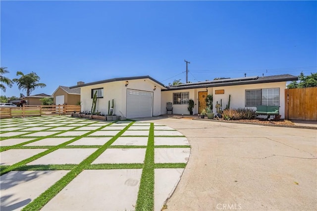 9551 Barkerville Ave, Whittier, CA 90605 - single story home with concrete driveway, an attached garage, stucco siding, and solar panels