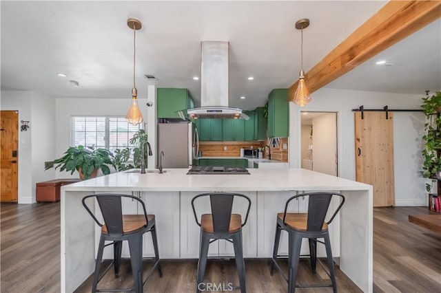 9551 Barkerville Ave, Whittier, CA 90605 - kitchen featuring appliances with stainless steel finishes, island range hood, a sink, a barn door, and dark wood-style flooring