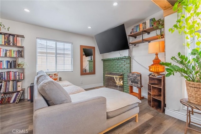 9551 Barkerville Ave, Whittier, CA 90605 - living room featuring wood finished floors, recessed lighting, a glass covered fireplace, and baseboards