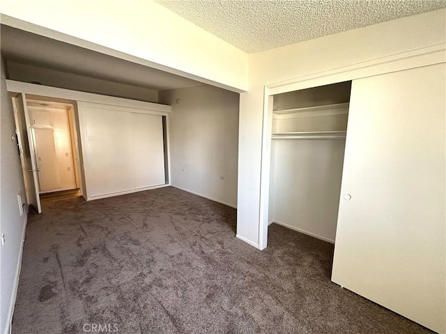 13540 Saint Andrews Dr Unit M14-4J, Seal Beach, CA 90740 - unfurnished bedroom with carpet, a closet, a textured ceiling, and baseboards