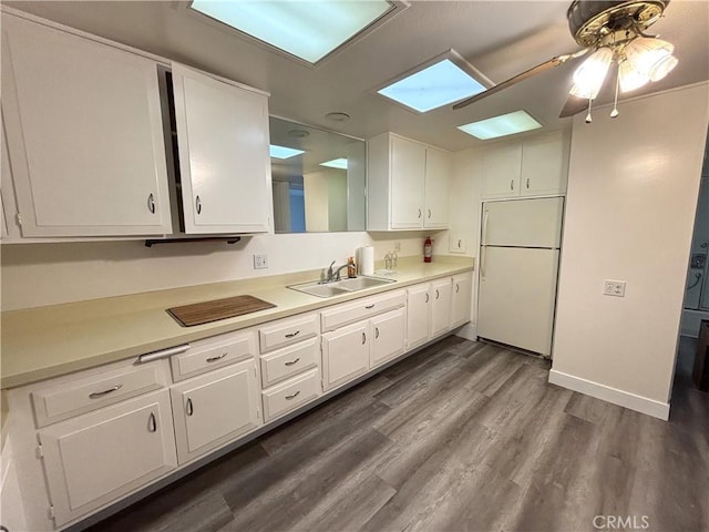 13540 Saint Andrews Dr Unit M14-4J, Seal Beach, CA 90740 - kitchen featuring white refrigerator, a sink, white cabinetry, and light countertops