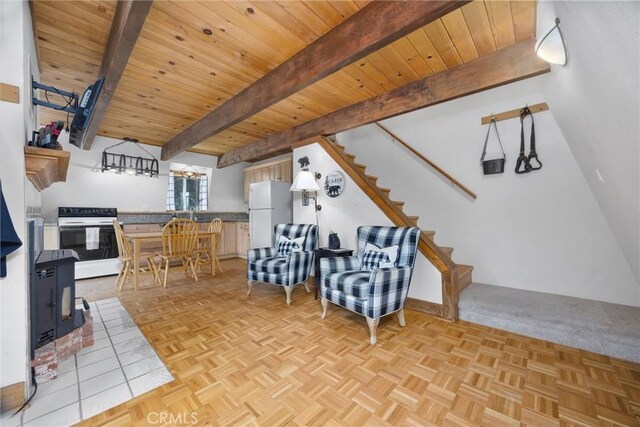 2320 Maplewood Way, Pine Mountain Club, CA 93222 - living area featuring a chandelier, stairway, wood ceiling with exposed beams, and a wood stove