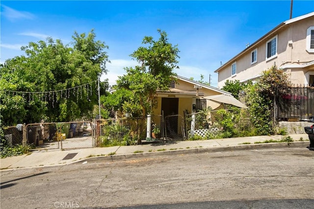 3339 E 4th St, Los Angeles, CA 90063 - obstructed view of property featuring a gate, a fenced front yard, and stucco siding