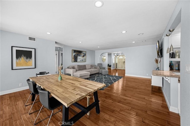 5345 Kenwood Ave, Buena Park, CA 90621 - dining room with baseboards, wood finished floors, a chandelier, recessed lighting, and arched walkways