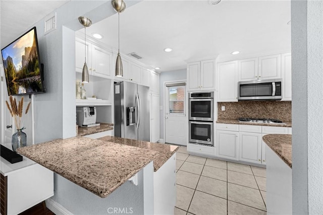 5345 Kenwood Ave, Buena Park, CA 90621 - kitchen with appliances with stainless steel finishes, white cabinetry, a peninsula, decorative backsplash, and stone counters