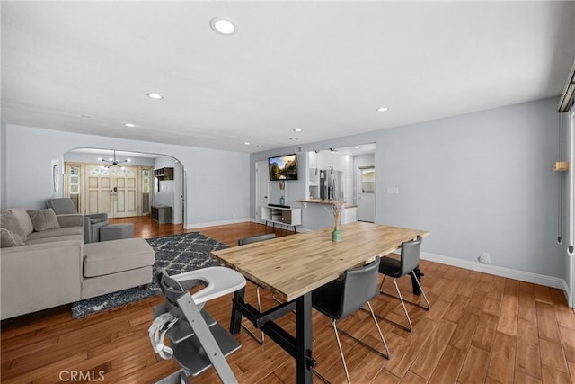 5345 Kenwood Ave, Buena Park, CA 90621 - dining space with arched walkways, baseboards, recessed lighting, and light wood-style flooring
