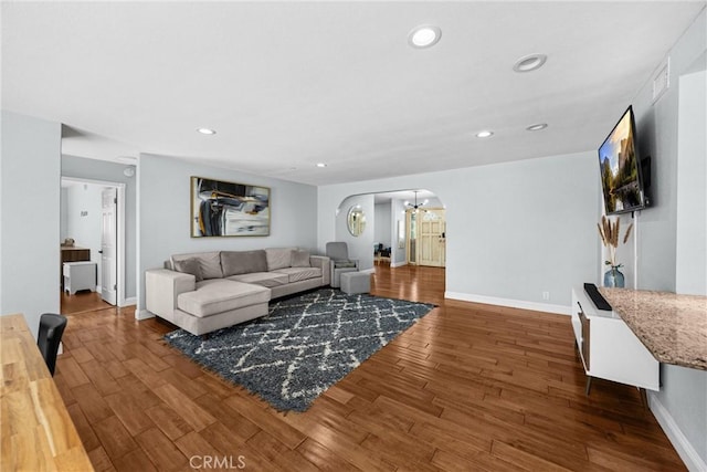 5345 Kenwood Ave, Buena Park, CA 90621 - living room with arched walkways, wood finished floors, baseboards, a chandelier, and recessed lighting