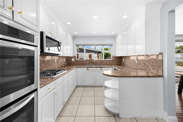 5345 Kenwood Ave, Buena Park, CA 90621 - kitchen featuring stainless steel appliances, a sink, healthy amount of natural light, open shelves, and recessed lighting