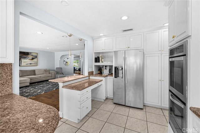 5345 Kenwood Ave, Buena Park, CA 90621 - kitchen with appliances with stainless steel finishes, a peninsula, white cabinetry, open floor plan, and recessed lighting