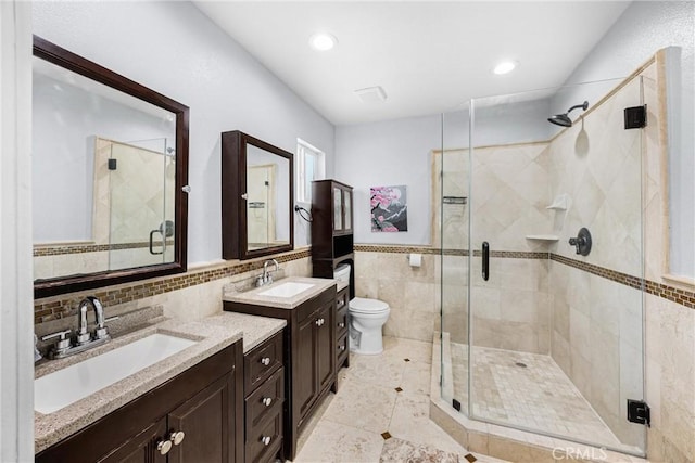 5345 Kenwood Ave, Buena Park, CA 90621 - full bath featuring tile walls, a shower stall, toilet, two vanities, and tile patterned floors