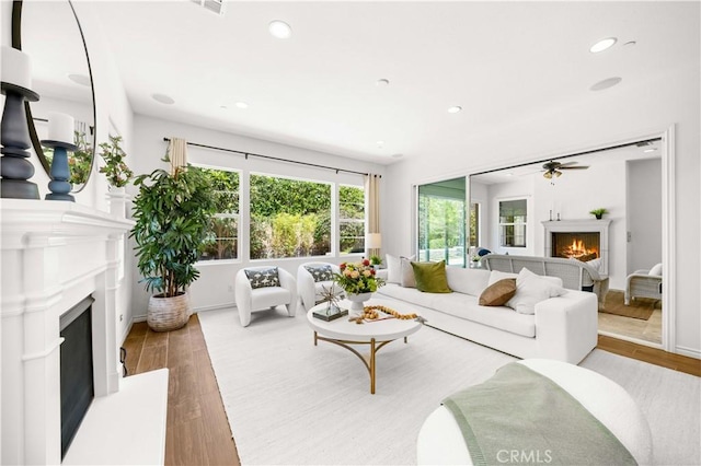 103 Sparrow, Irvine, CA 92618 - living area with a lit fireplace, wood finished floors, recessed lighting, ceiling fan, and baseboards