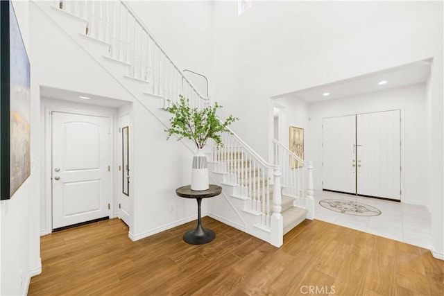 103 Sparrow, Irvine, CA 92618 - foyer featuring stairway, wood finished floors, recessed lighting, baseboards, and a towering ceiling