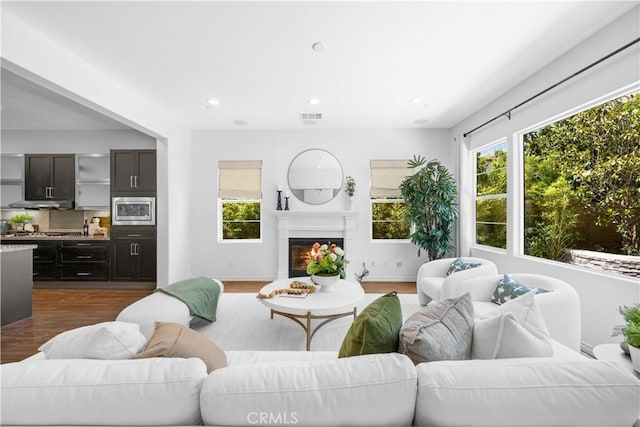 103 Sparrow, Irvine, CA 92618 - living area featuring dark wood-type flooring, recessed lighting, and a glass covered fireplace