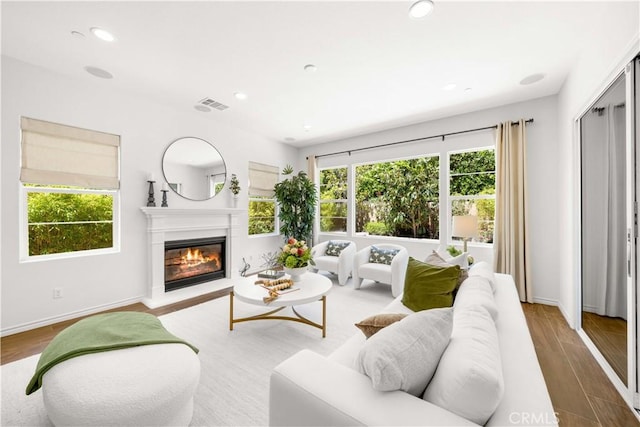 103 Sparrow, Irvine, CA 92618 - living room featuring plenty of natural light, a glass covered fireplace, baseboards, and recessed lighting