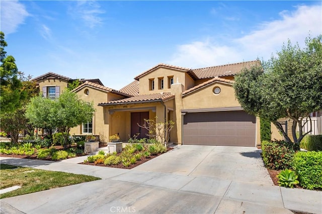 103 Sparrow, Irvine, CA 92618 - mediterranean / spanish house featuring an attached garage, driveway, stucco siding, and a tiled roof
