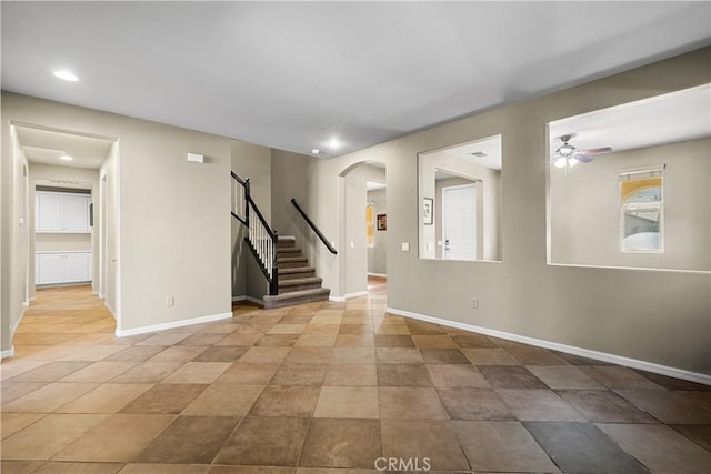 2123 Coconut Pl, Palmdale, CA 93551 - spare room featuring arched walkways, a ceiling fan, stairway, and recessed lighting