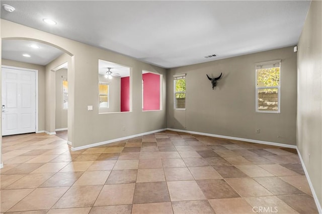 2123 Coconut Pl, Palmdale, CA 93551 - spare room featuring arched walkways, plenty of natural light, a ceiling fan, light tile patterned flooring, and recessed lighting