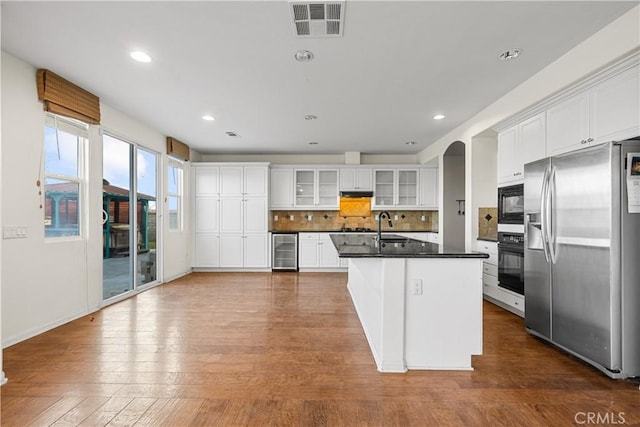 2123 Coconut Pl, Palmdale, CA 93551 - kitchen featuring black appliances, wine cooler, dark countertops, under cabinet range hood, and backsplash
