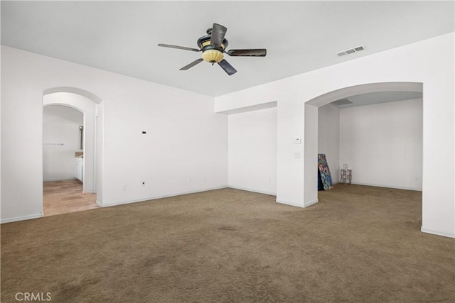 2123 Coconut Pl, Palmdale, CA 93551 - empty room with carpet floors, a ceiling fan, and arched walkways