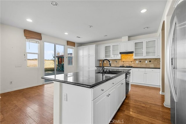 2123 Coconut Pl, Palmdale, CA 93551 - kitchen with stainless steel refrigerator, dark countertops, tasteful backsplash, wood finished floors, and recessed lighting