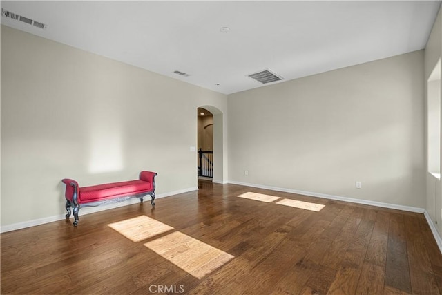 2123 Coconut Pl, Palmdale, CA 93551 - empty room featuring arched walkways and wood finished floors