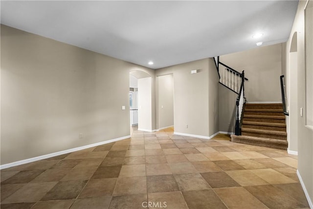 2123 Coconut Pl, Palmdale, CA 93551 - unfurnished room featuring arched walkways, recessed lighting, and stairway