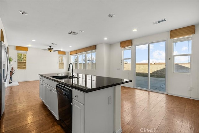 2123 Coconut Pl, Palmdale, CA 93551 - kitchen with dishwasher, dark countertops, hardwood / wood-style floors, and recessed lighting