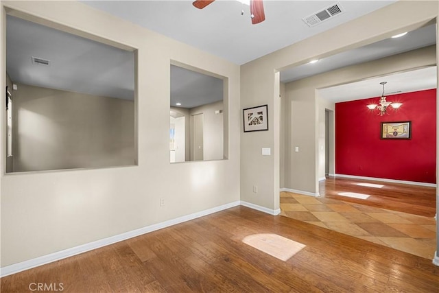 2123 Coconut Pl, Palmdale, CA 93551 - unfurnished room featuring a ceiling fan, wood finished floors, and a chandelier