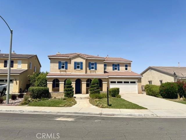 2123 Coconut Pl, Palmdale, CA 93551 - mediterranean / spanish home with stucco siding, concrete driveway, a tiled roof, and an attached garage