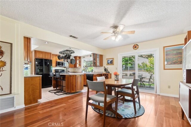 2482 Limestone Ct, Chino Hills, CA 91709 - dining space featuring light wood-style floors, ceiling fan, a textured ceiling, and baseboards