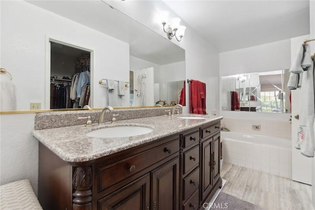 2482 Limestone Ct, Chino Hills, CA 91709 - bathroom with double vanity, a bath, and a walk in closet