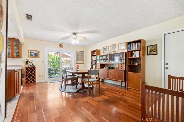 2482 Limestone Ct, Chino Hills, CA 91709 - dining area with light wood-type flooring, a textured ceiling, a ceiling fan, and baseboards