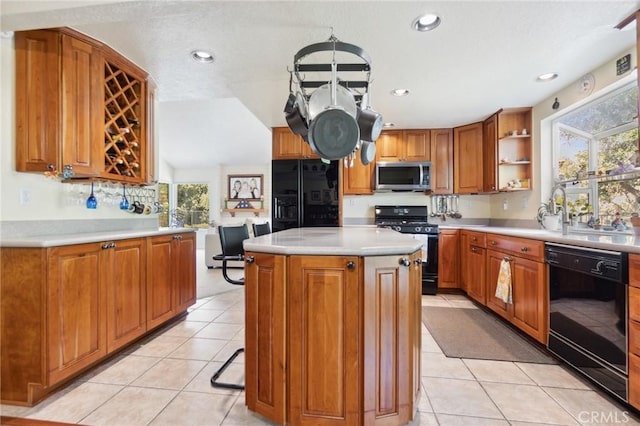 2482 Limestone Ct, Chino Hills, CA 91709 - kitchen with black appliances, plenty of natural light, brown cabinets, light tile patterned floors, and recessed lighting